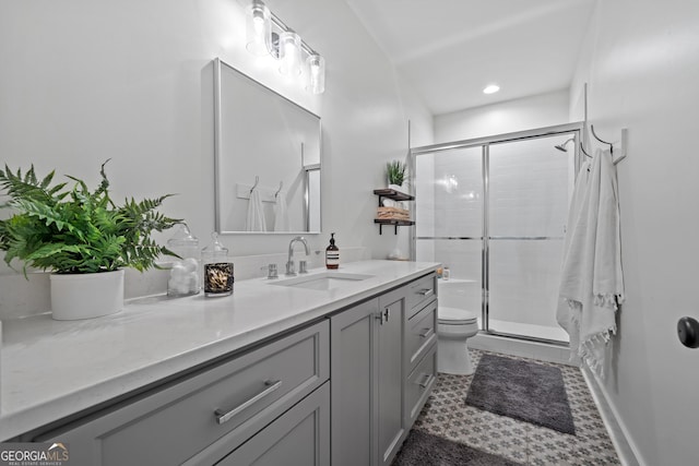 bathroom with vanity, an enclosed shower, tile patterned flooring, and toilet