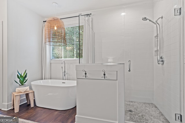 bathroom featuring wood-type flooring and separate shower and tub