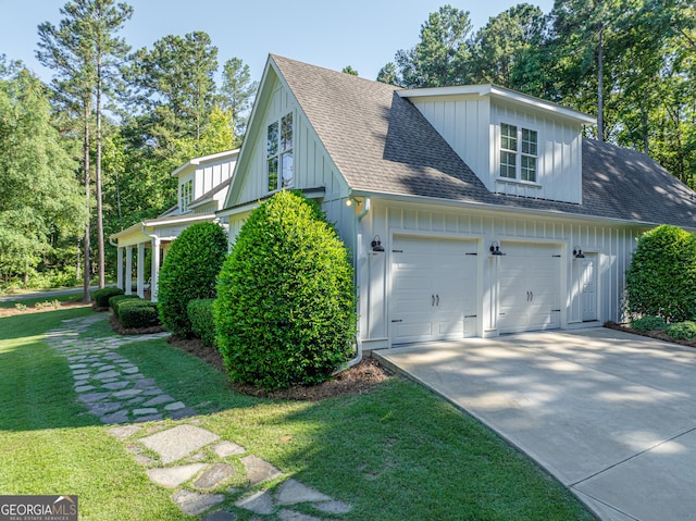 view of side of property with a garage and a yard