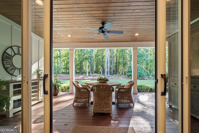 sunroom featuring wood ceiling and ceiling fan