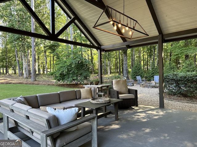 view of patio featuring ceiling fan and an outdoor living space with a fire pit