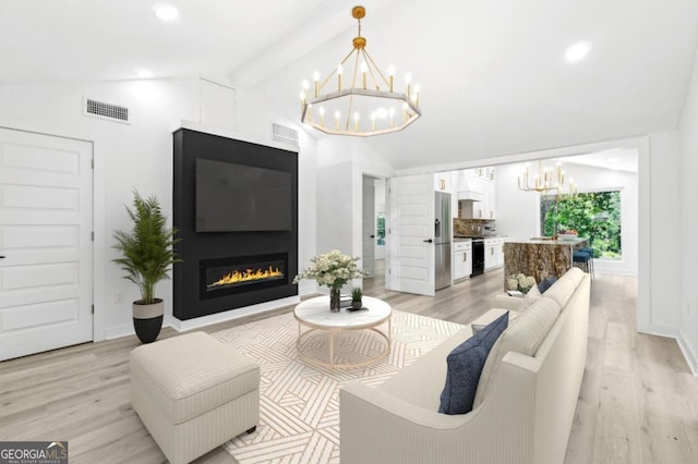 living room with light wood-type flooring, lofted ceiling with beams, and a notable chandelier