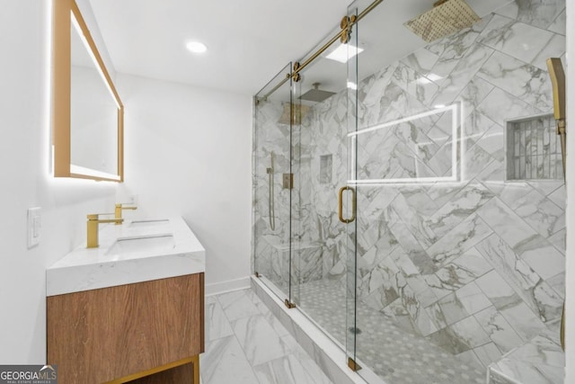 bathroom featuring a shower with shower door and vanity