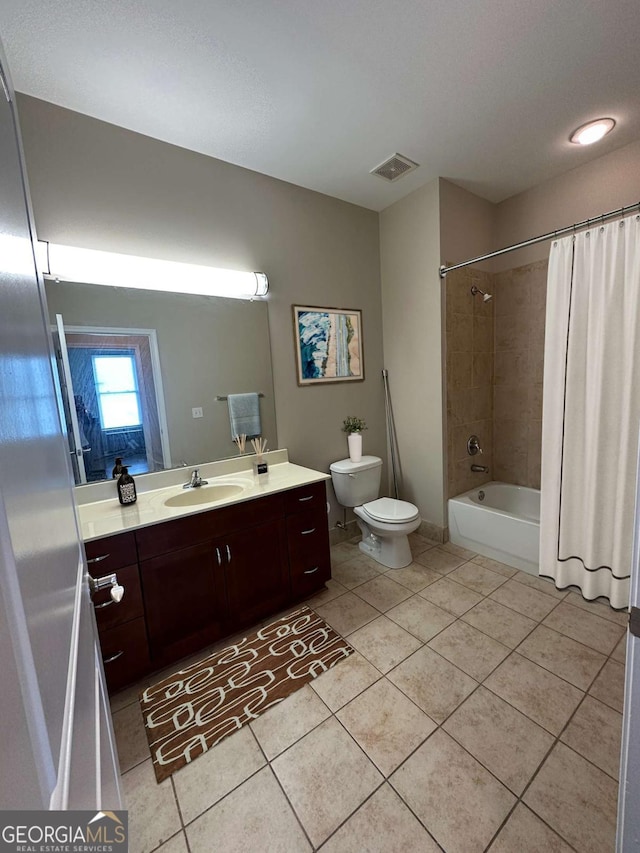 full bathroom featuring vanity, shower / bath combo, tile patterned floors, and toilet