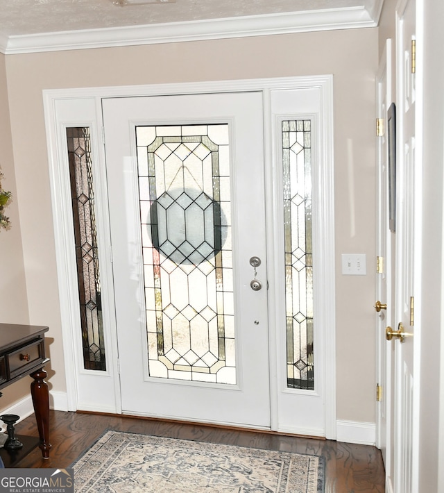 foyer with baseboards, ornamental molding, and dark wood finished floors