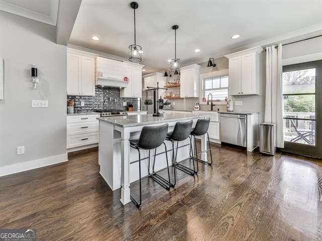 kitchen featuring backsplash, open shelves, a kitchen bar, stainless steel dishwasher, and dark wood-style flooring