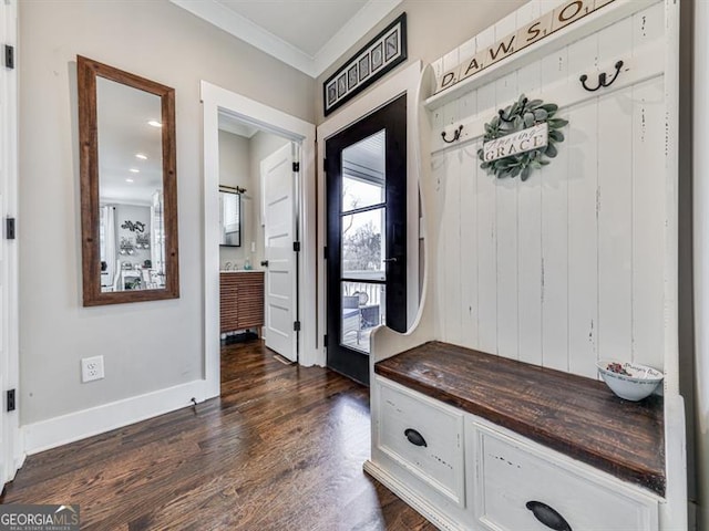 mudroom with crown molding, dark wood-style floors, and baseboards