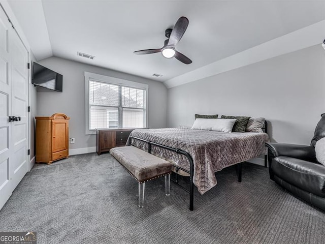 carpeted bedroom with visible vents, lofted ceiling, baseboards, and ceiling fan