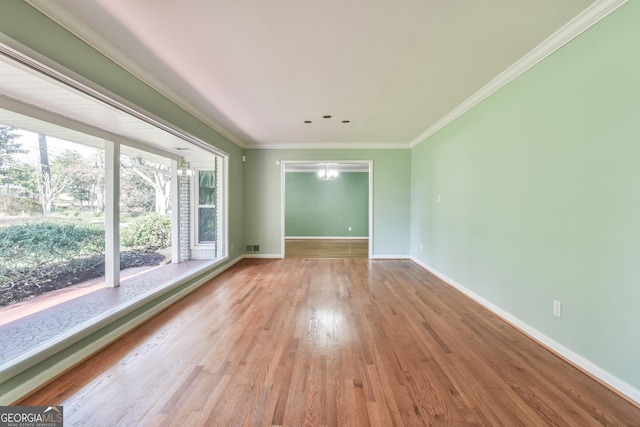 unfurnished room featuring light hardwood / wood-style flooring and crown molding