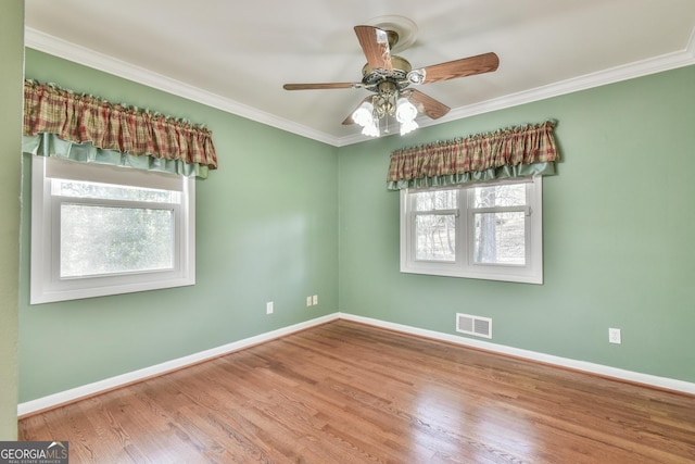 empty room featuring ceiling fan, ornamental molding, and light hardwood / wood-style flooring