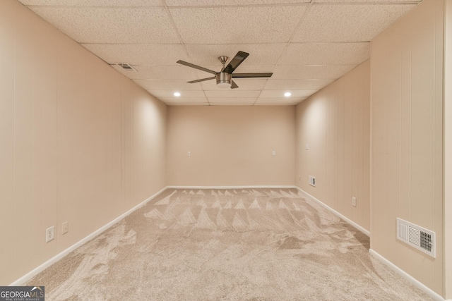 carpeted spare room with ceiling fan and a paneled ceiling