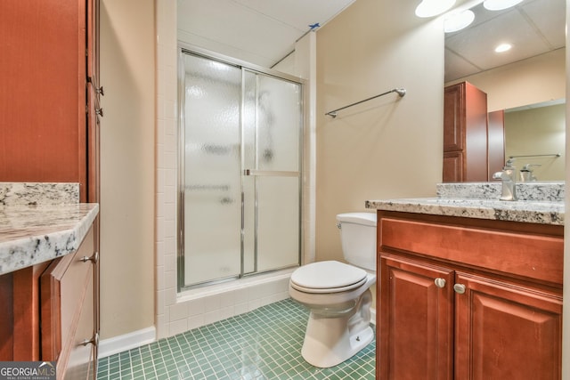 bathroom featuring tile patterned floors, toilet, vanity, and walk in shower