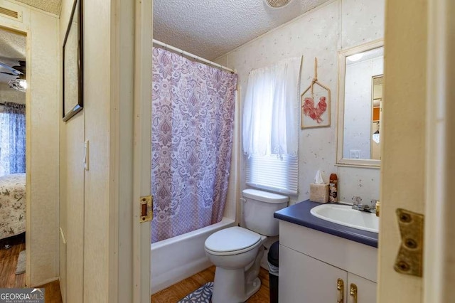 full bathroom with toilet, shower / tub combo, a textured ceiling, vanity, and hardwood / wood-style floors