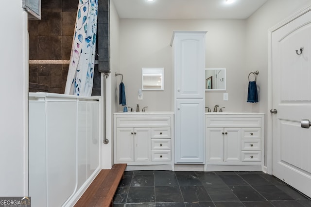 full bath featuring tiled shower and vanity