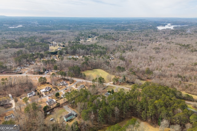 birds eye view of property featuring a forest view