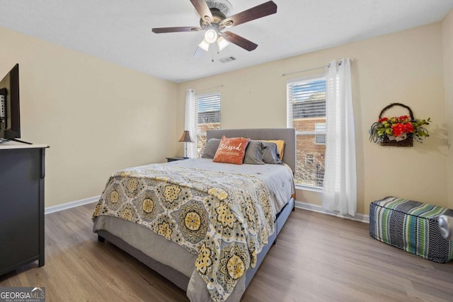 bedroom with ceiling fan and light hardwood / wood-style flooring