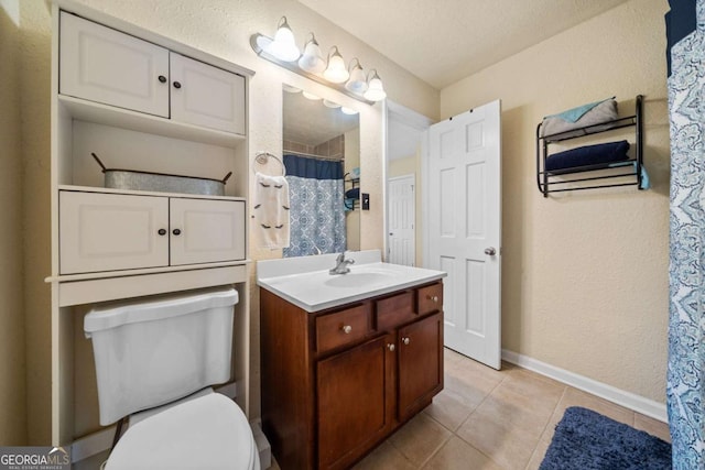 bathroom with vanity, curtained shower, tile patterned floors, and toilet