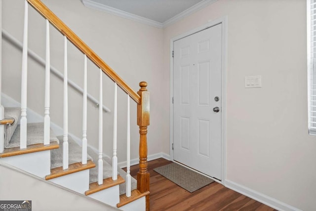 foyer entrance with hardwood / wood-style flooring and ornamental molding