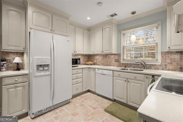 kitchen with sink, tasteful backsplash, ornamental molding, pendant lighting, and white appliances