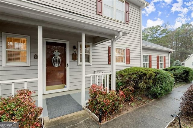 view of exterior entry with covered porch