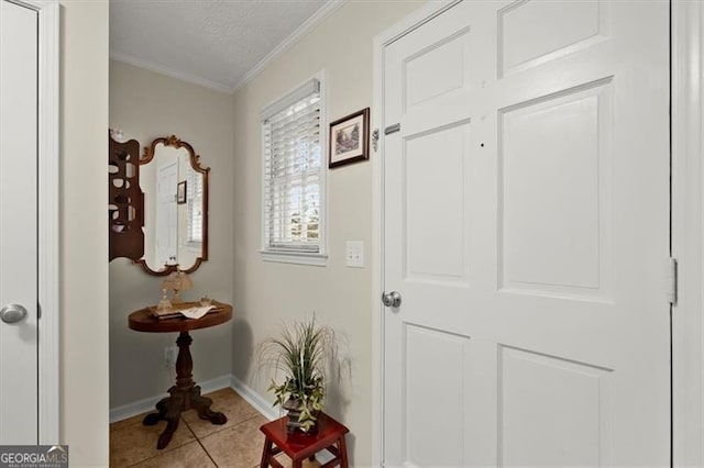 entryway featuring light tile patterned flooring, a textured ceiling, and crown molding