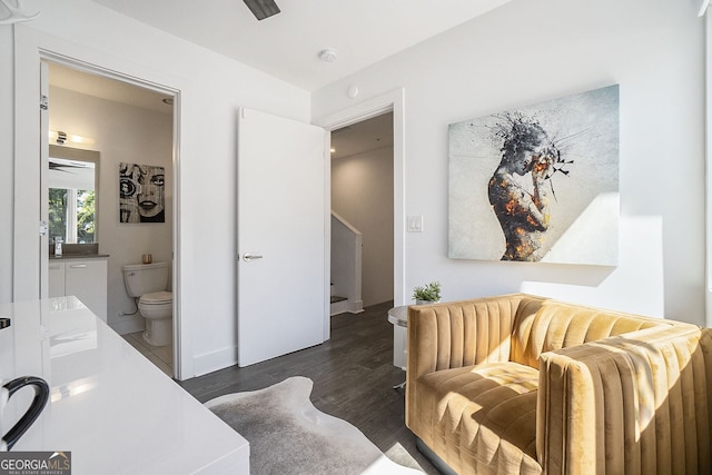 bedroom with dark hardwood / wood-style flooring and ensuite bathroom