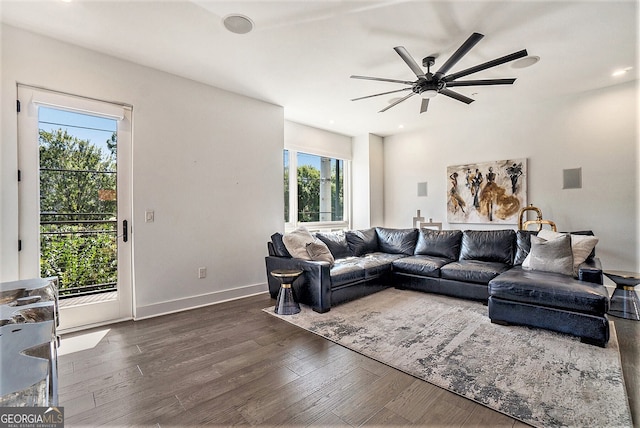 living room with dark wood-type flooring and ceiling fan