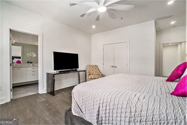 bedroom featuring dark hardwood / wood-style flooring, connected bathroom, and ceiling fan