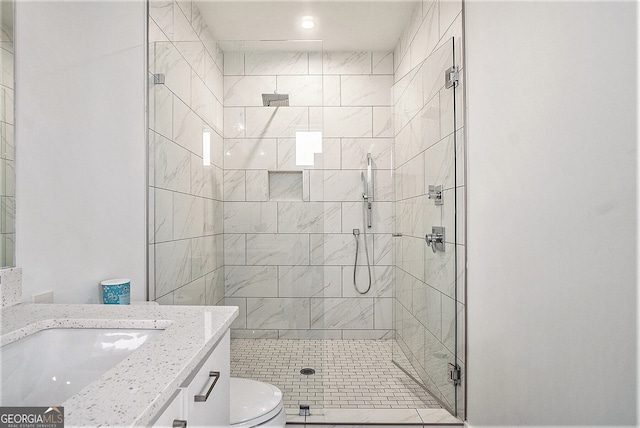 bathroom featuring vanity, toilet, and an enclosed shower