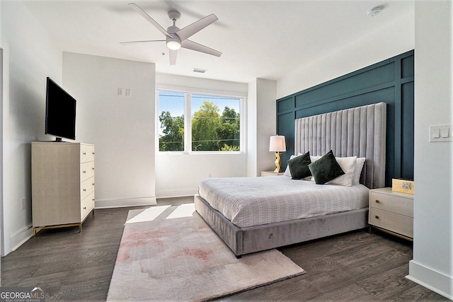 bedroom with ceiling fan and dark hardwood / wood-style flooring