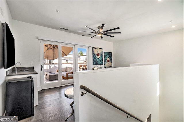 interior space with ceiling fan, sink, and hardwood / wood-style floors