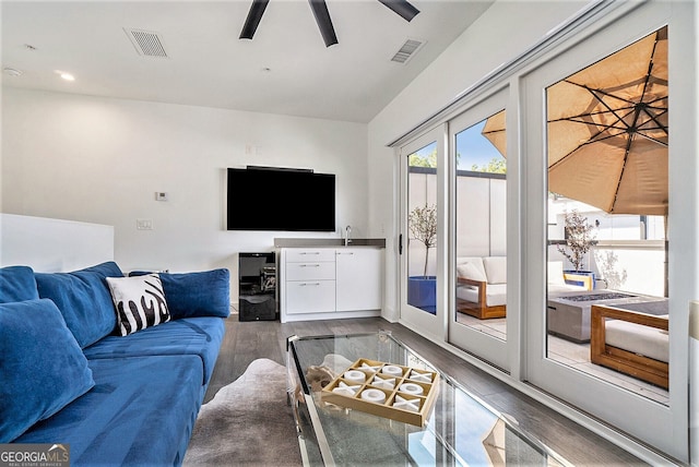 living room with dark hardwood / wood-style floors and ceiling fan