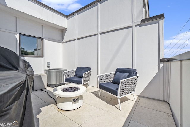 view of patio featuring cooling unit and an outdoor fire pit