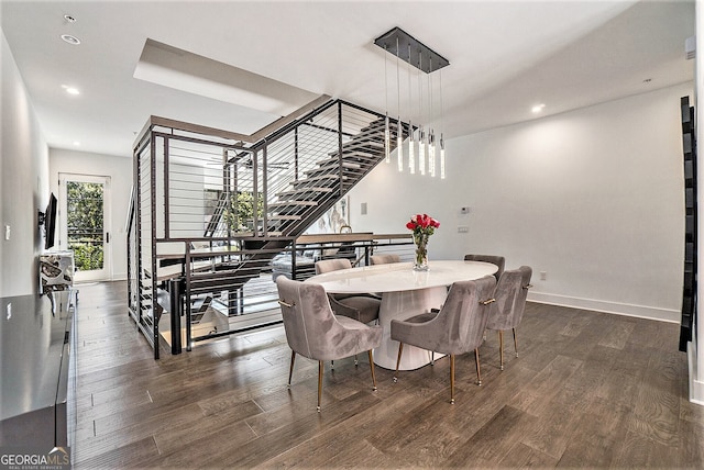 dining space with dark hardwood / wood-style flooring