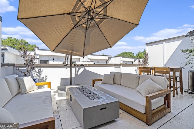 view of patio featuring an outdoor living space with a fire pit