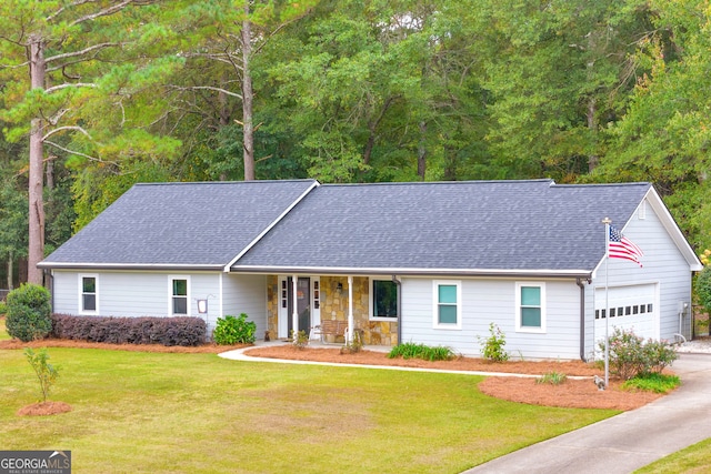 ranch-style house featuring a garage, covered porch, and a front lawn