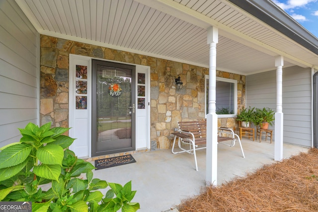 doorway to property featuring covered porch