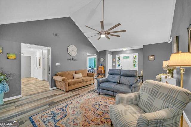 living room with ceiling fan, wood-type flooring, and high vaulted ceiling