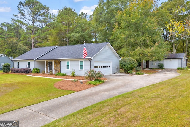 view of front of house with an outbuilding, a garage, and a front yard