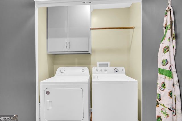 laundry area featuring cabinets and separate washer and dryer