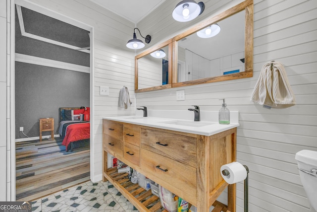 bathroom featuring crown molding, vanity, and toilet