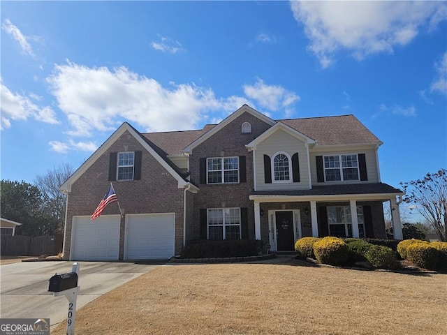 view of front of house with brick siding, a front yard, an attached garage, and driveway