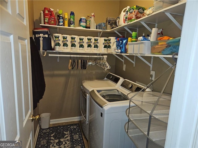 laundry room featuring baseboards, separate washer and dryer, and laundry area