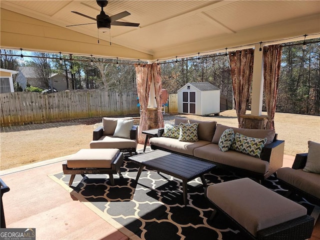 view of patio with a ceiling fan, fence, a shed, an outdoor structure, and outdoor lounge area