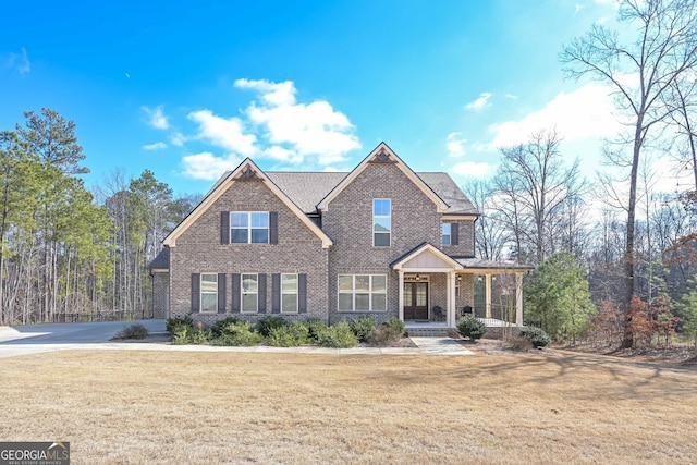 craftsman house with a front yard and covered porch