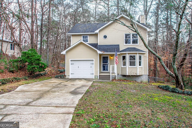 view of front property with a garage and a front yard