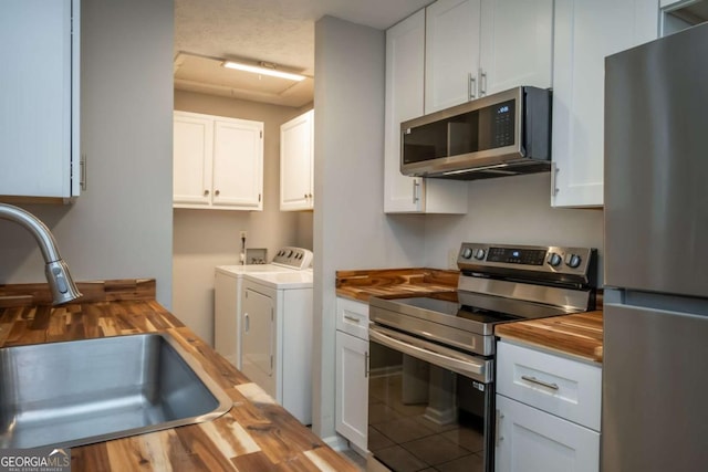 100 Downing Way Unit E, Athens, GA 30606 - kitchen featuring wood counters, sink, white cabinets, stainless steel appliances, and washer and clothes dryer