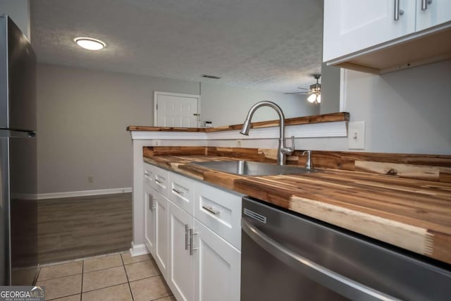 100 Downing Way Unit E, Athens, GA 30606 - kitchen featuring sink, a textured ceiling, white cabinets, and appliances with stainless steel finishes