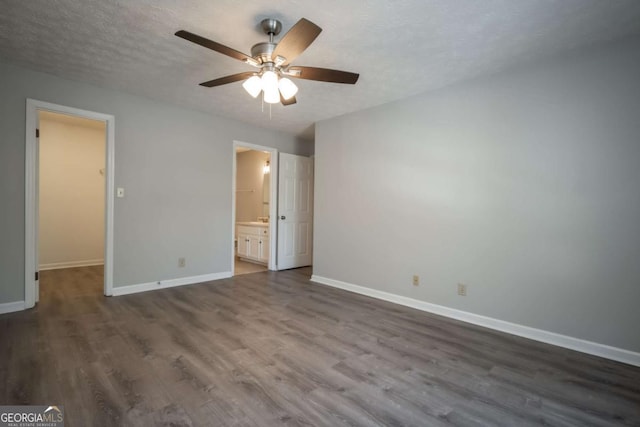 100 Downing Way Unit E, Athens, GA 30606 - unfurnished bedroom with ensuite bath, dark wood-type flooring, ceiling fan, a textured ceiling, and a spacious closet