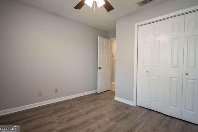 100 Downing Way Unit E, Athens, GA 30606 - unfurnished bedroom with hardwood / wood-style flooring, a textured ceiling, ceiling fan, and a closet